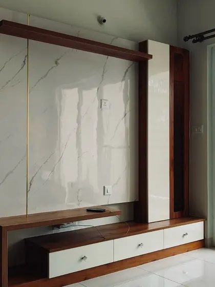 A close-up of the elegant TV unit with a marble and wood finish, showcasing the high-quality materials and craftsmanship.