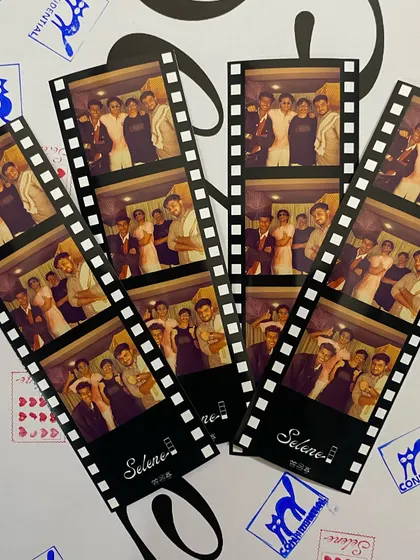 A collection of filmstrip-style prints scattered on a table with custom stamps. The possibilities for customization are endless.