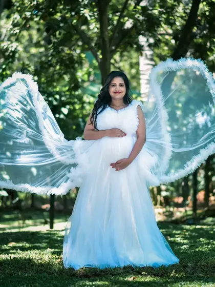 This client looks like an angel with the gown's trail spread out like wings. This white ruffled gown is a popular rental choice for its dreamy and ethereal quality.