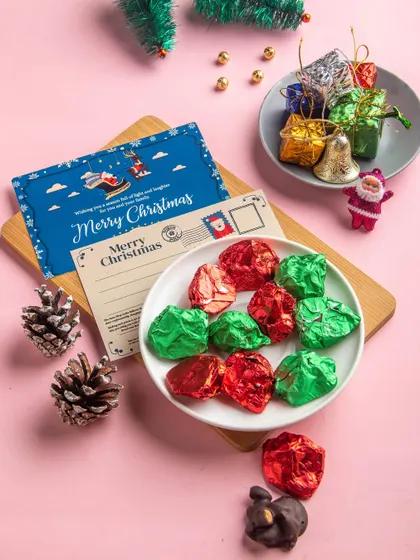 Our Assorted Chocolate Rocks are a crunchy, nutty delight. This image shows them unwrapped, revealing the delicious combination of cashews, almonds, and chocolate.