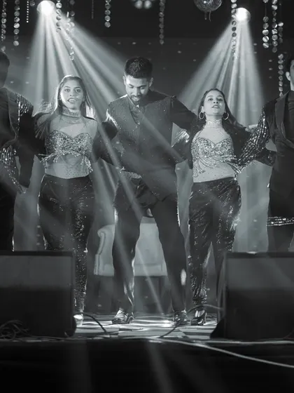 A black and white shot of a professional dance troupe performing on stage. I work with top choreographers and artists to bring a high level of entertainment to your wedding events.