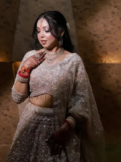 A close-up of the bride, highlighting the soft, shimmery eye makeup and the delicate hair accessory.