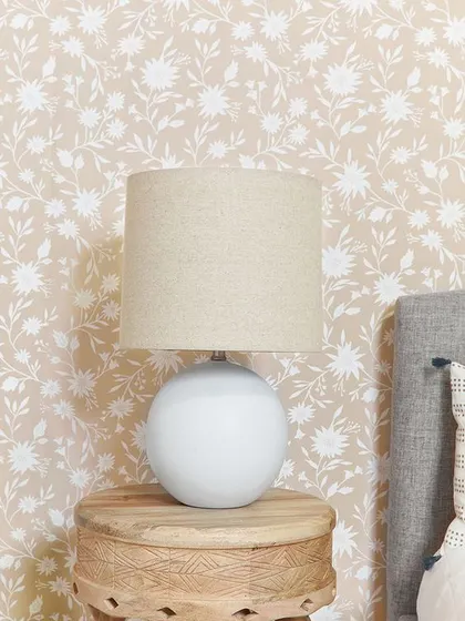 A delicate and pretty wallpaper with a small-scale white floral pattern on a beige background. It's a subtle and charming choice for a bedroom or powder room.