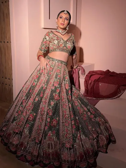 A full-length shot of the floral lehenga. The combination of the printed skirt and the embroidered blouse is both traditional and modern.