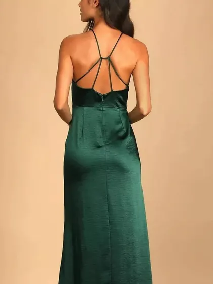 The back of the emerald green satin gown, featuring a delicate criss-cross strap design that makes for an elegant exit.