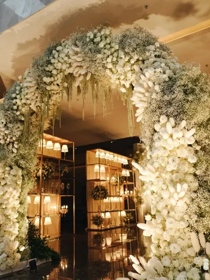 An ethereal floral archway crafted from clouds of baby's breath and white tuberoses. This entrance was designed to make guests feel like they were stepping into a dream, setting a tone of pure elegance.