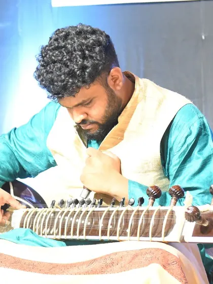 Tuning the sitar just before a performance. It's a crucial step to ensure every note, especially the sympathetic strings that resonate underneath, sounds perfect.