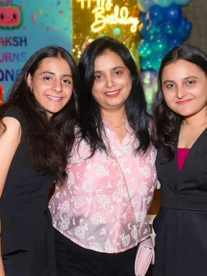 Three generations of women celebrating the youngest family member's first birthday.