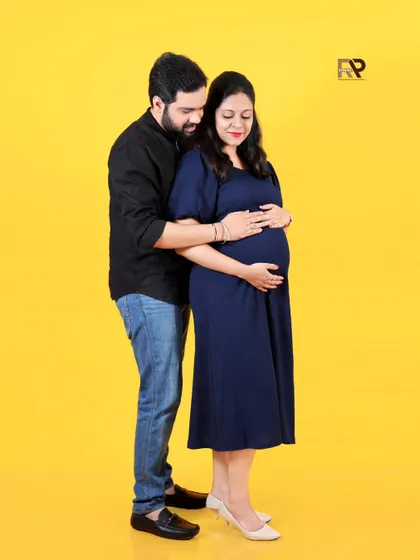 A classic couple's pose with a modern twist. The solid yellow background adds a pop of color and joy to this loving portrait.