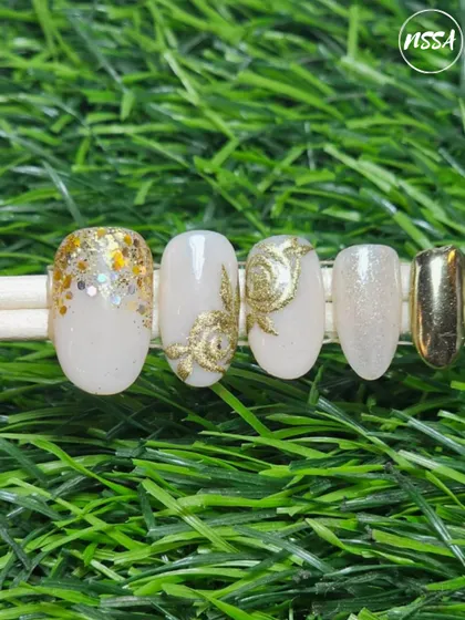 A collection of various nail art samples, from celestial and gold-leaf designs to embossed sweater patterns and fruit art, all showcasing the diverse skills our students learn at the academy.