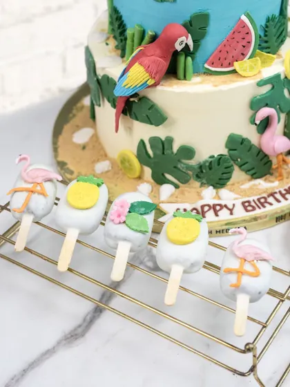 These tropical-themed cakesicles were part of the dessert table for Aadya's birthday. I handcrafted little flamingos and pineapple tops to sit on each one, tying the whole theme together.