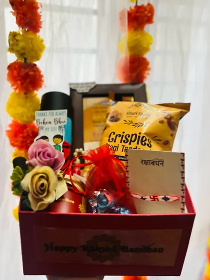 A compact and thoughtful Rakhi gift box, held in hand to show its convenient size.