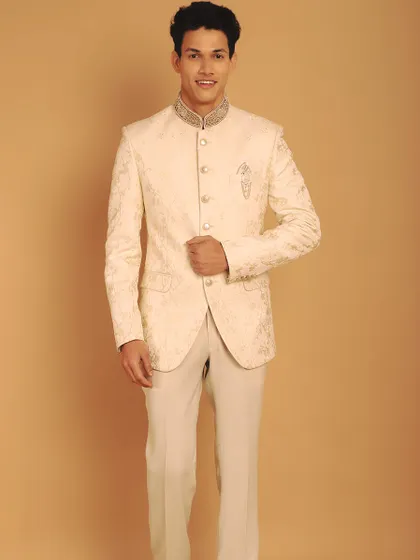 An ivory Jodhpuri suit is a statement of pure class. This piece features tone-on-tone thread work with dull gold zardozi, creating a look that is both understated and incredibly regal.
