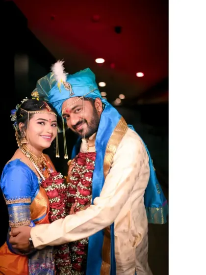 A happy portrait of the couple after the main ceremony, embracing and smiling for the camera.