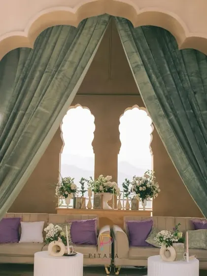 A view of the lounge through the elegant archway, framed by soft green drapes. The setup was designed to feel like a private, luxurious retreat high above the city.