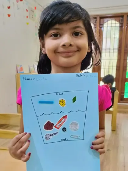 A proud student shows her worksheet where she has correctly sorted objects that float and sink. This reinforces the concepts learned during our science experiment.