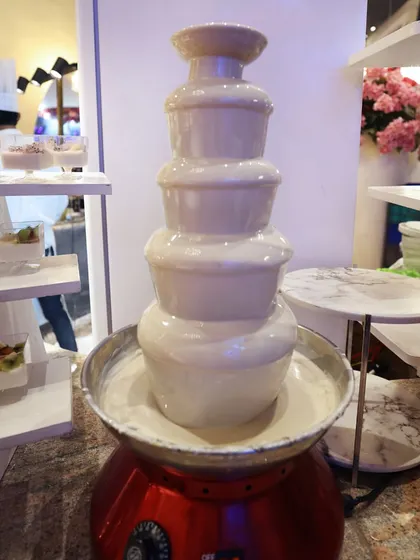 A white chocolate fountain, offering a sweet and creamy alternative to the classic dark chocolate. Our fountains are always a fun and interactive centerpiece for any dessert station.
