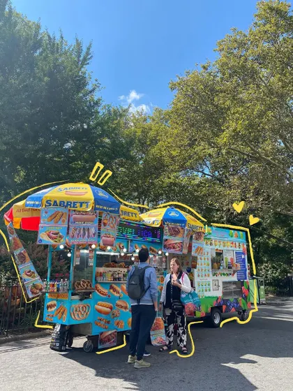 A classic New York hot dog stand, outlined in yellow to make it pop.