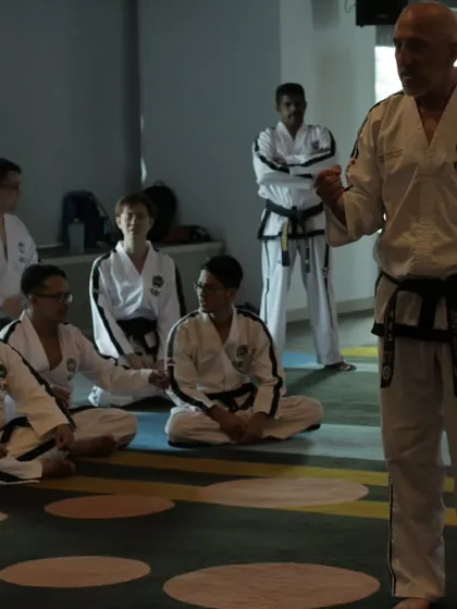 Listening intently as a Grand Master explains a principle of Taekwon-Do. To be a good teacher, I must always remain a student.