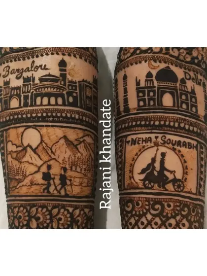 A close-up of the storytelling panels on the arms. On the left, the Bangalore skyline and a trekking scene. On the right, the Delhi skyline and a cute caricature of the couple on a bicycle.
