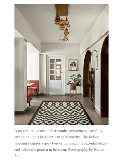 This feature showcases the restaurant's hallway, noting the custom-made chandelier and the trapezoidal black-and-white tile pattern that enhances the heritage character of the space.