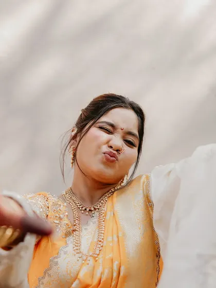 A fun, candid moment that shows the bride's personality shining through. Even in full traditional attire, it's all about feeling like yourself.