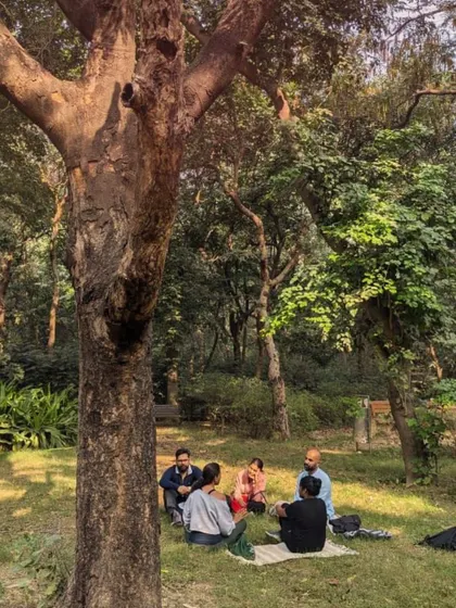 A serene moment as our group sits together on the grass, surrounded by trees. This image perfectly captures the peace and tranquility of our forest bathing sessions.