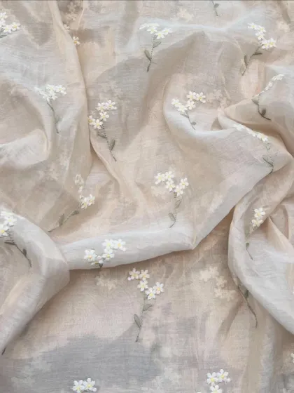 Light as a whisper, this Chanderi tissue fabric features delicate white floral embroidery. Its subtle sheen and airy feel make it perfect for elegant sarees and dupattas.