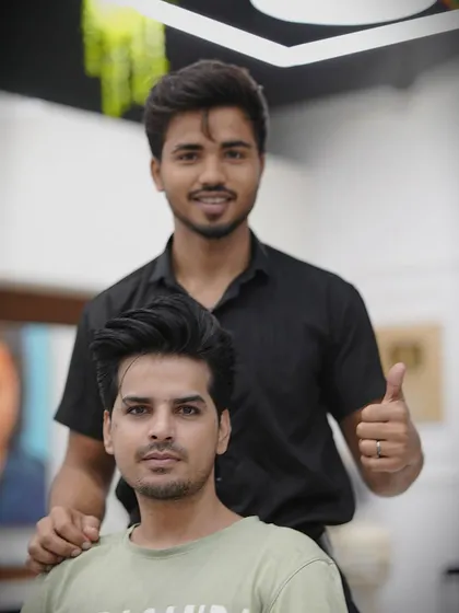 A happy client and his stylist after a successful haircut. That's what we aim for every time.