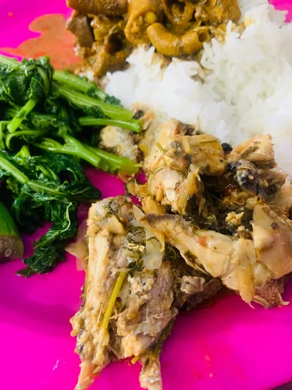 A simple thali with fish, beef innards, and boiled greens.