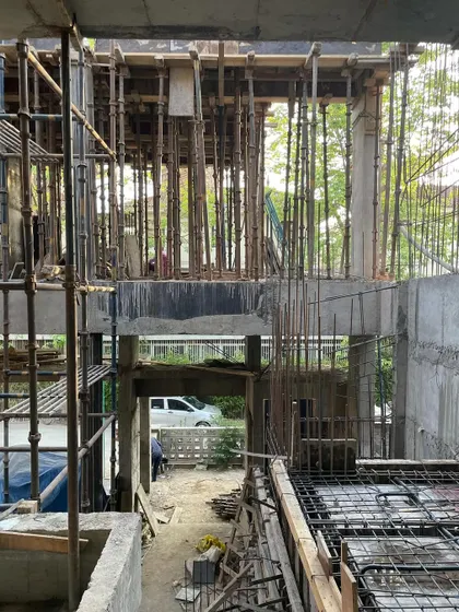 **Dwelling in Splits, Ahmedabad:** The interior under construction, with scaffolding revealing the complex volumes. The design is a spatial study of how to create both private retreats and moments of togetherness within a single home.