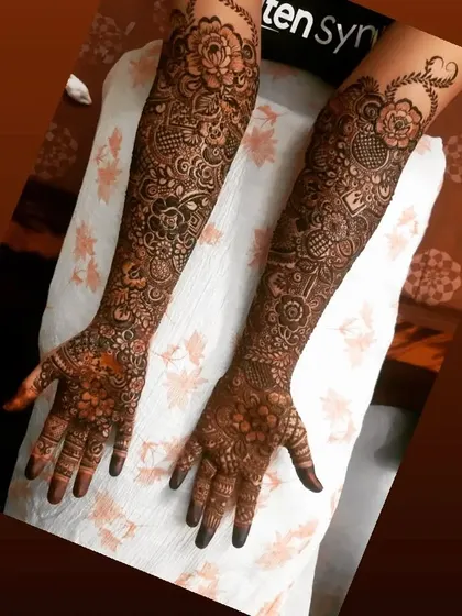 Misba's bridal henna, a full floral design that is both elegant and intricate. The flowers cascade down her arms for a beautiful effect.