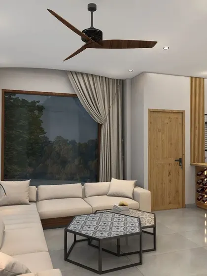 This cozy lounge area in a Nainital villa features an L-shaped sofa and hexagonal center tables with Moroccan tile tops, overlooking scenic views through large windows.