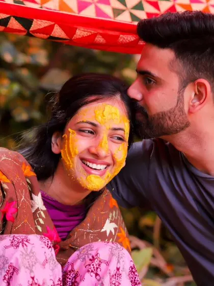 A loving kiss on the forehead during the Haldi. The vibrant colours and the couple's joyful expressions make this a heartwarming and memorable photograph.