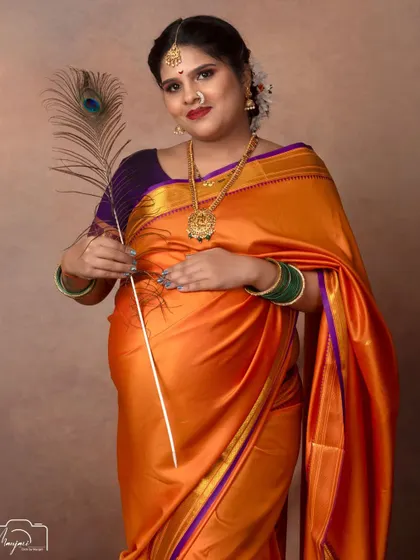 A solo portrait with a peacock feather, a nod to Lord Krishna and a symbol of grace and beauty.
