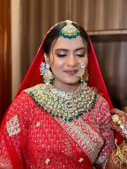 A closer look at the flawless base and soft eye makeup that lets the heavy jewellery and bold outfit shine.
