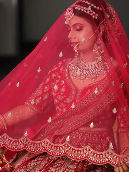 This stunning bride in her red lehenga is a perfect example of a classic North Indian bridal look. We focused on radiant skin, bold eyes, and a traditional bridal bun adorned with flowers.