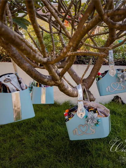 Beautifully customized welcome baskets for guests at a Goa wedding, reflecting the pastel blue and silver theme of the event.