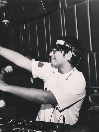 A black and white shot of me dancing behind the decks. I can't help but move to the music I play.
