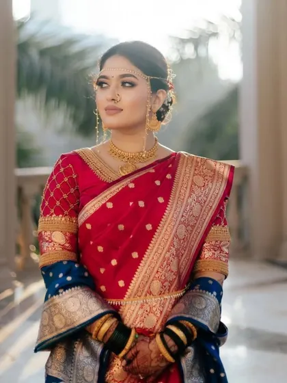 A regal portrait of our Maharashtra bride. The lighting beautifully captures the details of her saree, jewelry, and our subtle, enhancing makeup.
