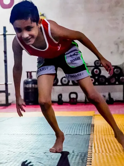 A young student works on his agility and balance. Our youth programs are designed to develop overall athleticism, not just fighting skills.