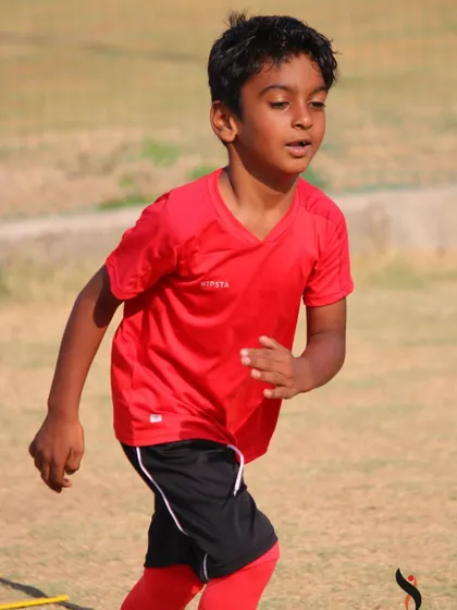This young athlete is completely absorbed in a running drill, a common sight at our action-packed summer camps.