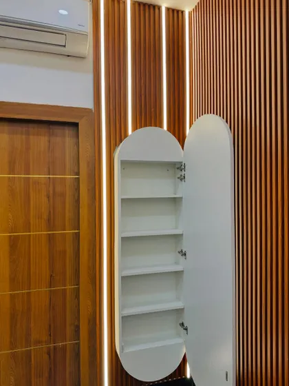 The hidden feature of the space-saving dressing unit. The oval mirror is actually a door that opens to reveal a slim cabinet with multiple shelves, perfect for storing cosmetics and accessories.