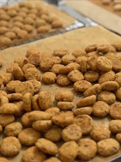 Freshly baked oat coconut cookie bites, cooling on a tray. We make these in small batches to ensure they are always fresh and delicious.