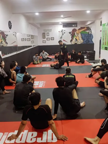 A wide view of our class during a technique demonstration. Everyone has a clear view of the coach, ensuring no detail is missed during the instruction.