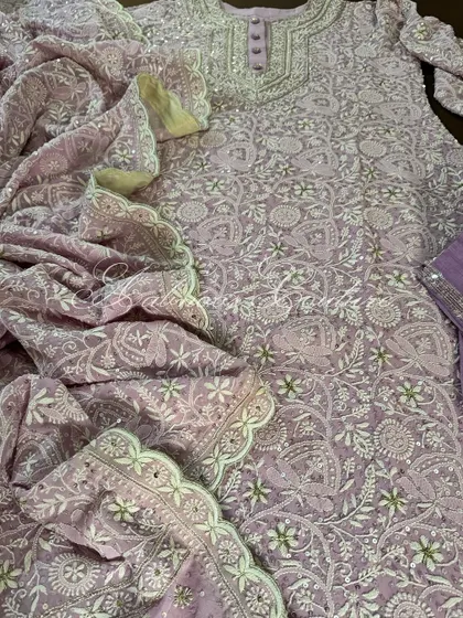 This image captures the flow and texture of the pure georgette fabric, covered in dense Chikankari jaal.