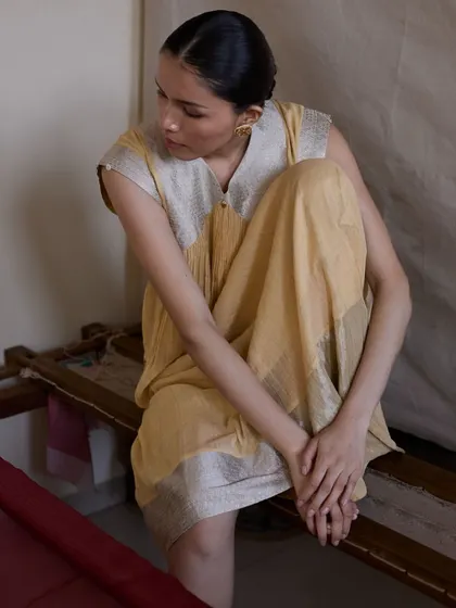 An introspective pose that highlights the texture and flow of the fabric. This kind of shot adds an emotional, narrative quality to a brand's lookbook.