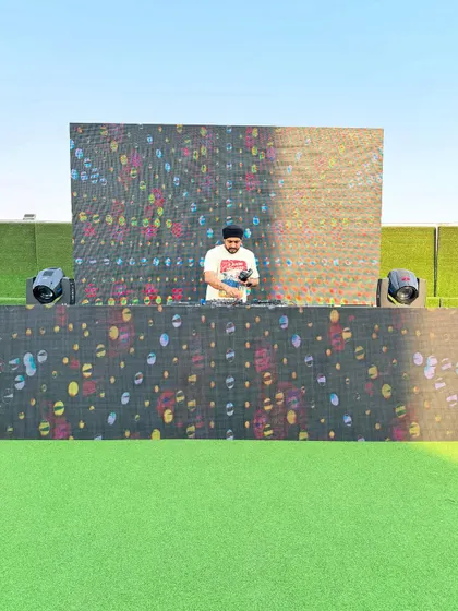 Getting the console ready for a Holi event. I make sure all equipment, including the DJ decks and the massive LED screen, is perfectly calibrated for an evening of music and celebration.