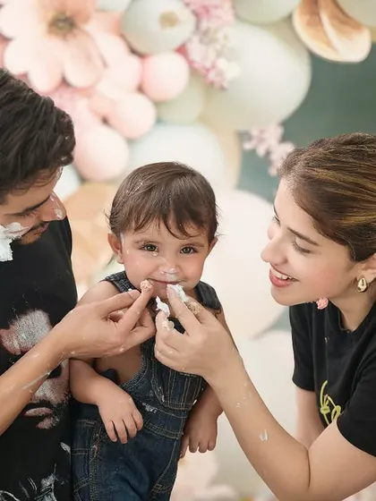 A beautiful family moment during a cake smash session. These candid interactions are often the most treasured photos from the day.