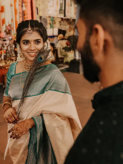 An over-the-shoulder shot of the bride looking at her groom, her smile radiant.